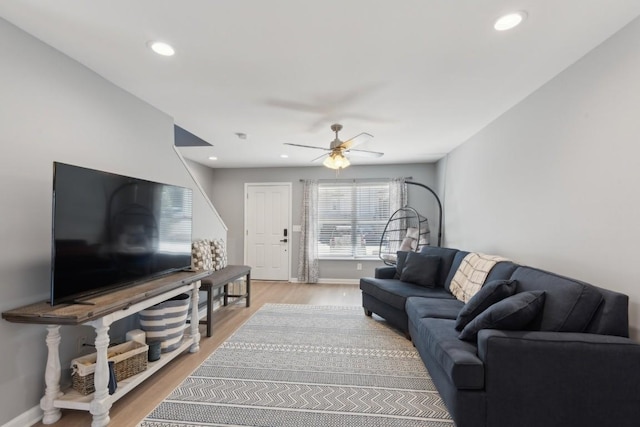 living room featuring ceiling fan and wood-type flooring