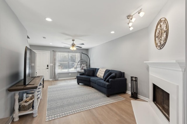 living room featuring ceiling fan and wood-type flooring