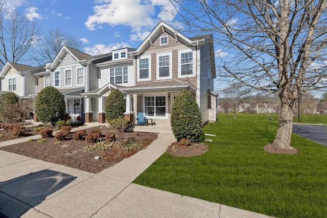 view of front of home featuring a front yard and a porch