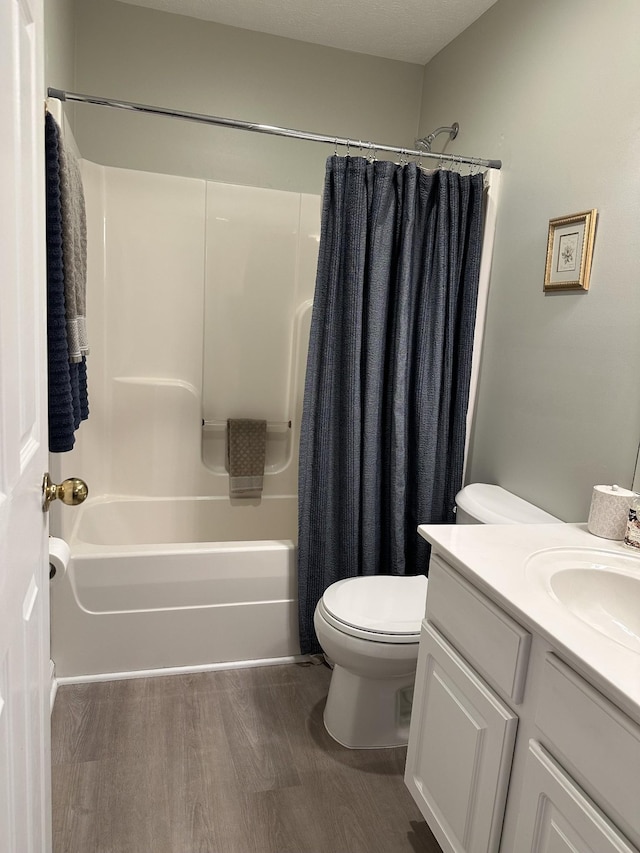 full bathroom featuring wood-type flooring, toilet, vanity, and shower / bath combo