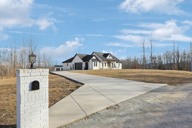 view of front of property featuring a garage and a front yard