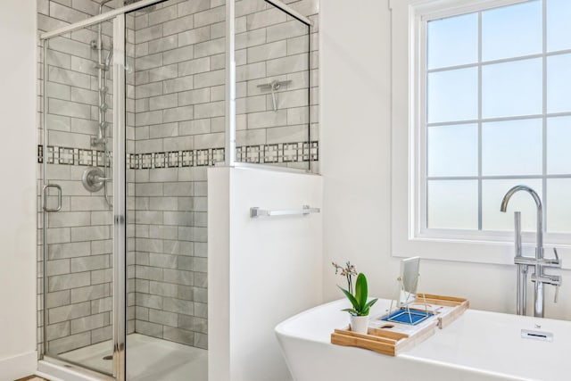 bathroom featuring separate shower and tub