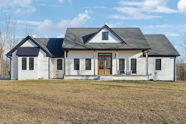 back of property with french doors, a patio area, and a lawn