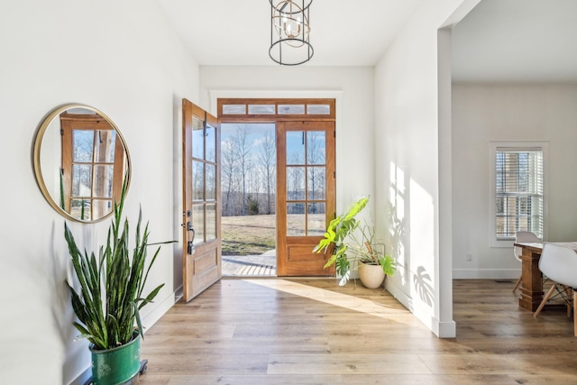 foyer featuring a notable chandelier and light hardwood / wood-style floors