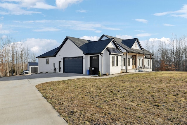 modern inspired farmhouse with a garage, a front lawn, and a porch