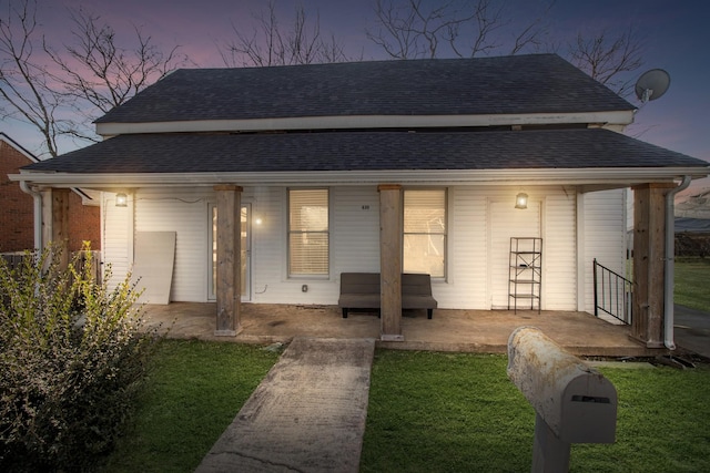 exterior space with a shingled roof and covered porch