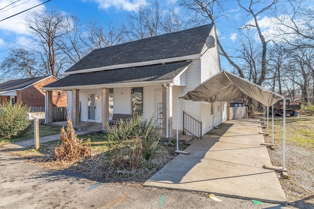 view of front of property with a carport, covered porch, a shingled roof, and driveway