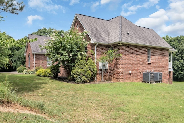 view of home's exterior featuring central AC and a lawn