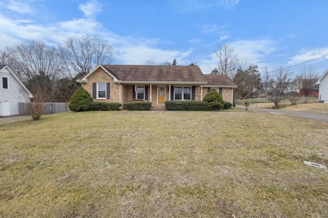 ranch-style home featuring a front yard