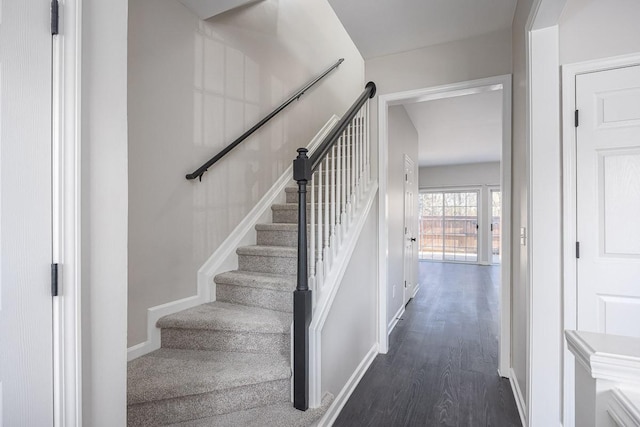 stairs featuring hardwood / wood-style flooring