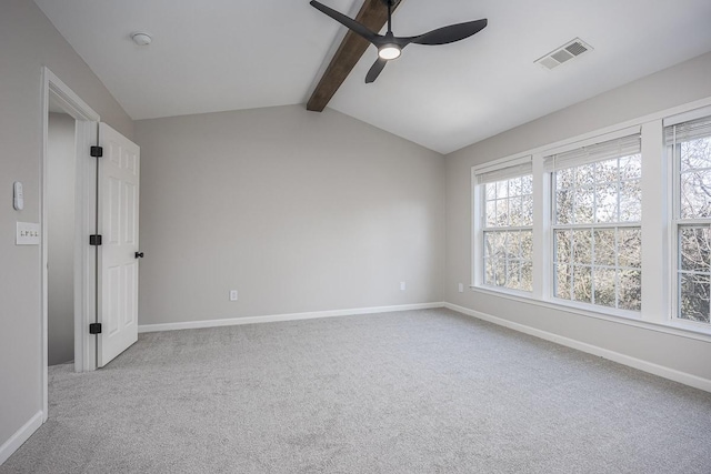 carpeted empty room featuring a healthy amount of sunlight, vaulted ceiling with beams, and ceiling fan