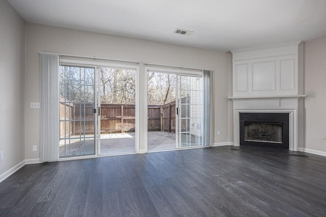 unfurnished living room with dark hardwood / wood-style flooring and a fireplace