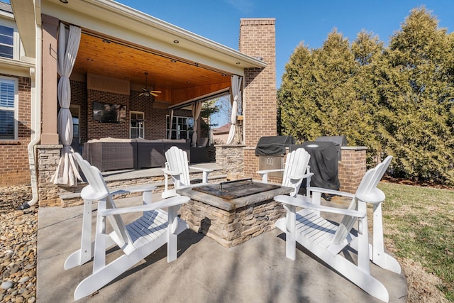 view of patio / terrace featuring ceiling fan, a grill, and an outdoor living space with a fire pit