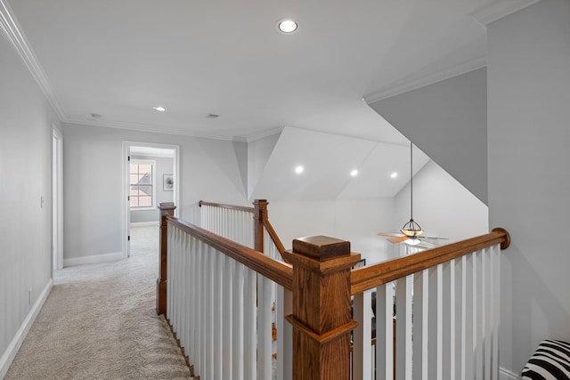 corridor featuring crown molding and light colored carpet