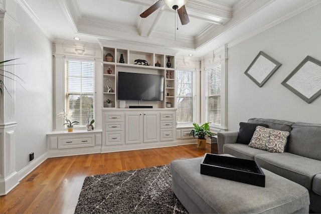 living room featuring coffered ceiling, crown molding, light wood-type flooring, ceiling fan, and beam ceiling