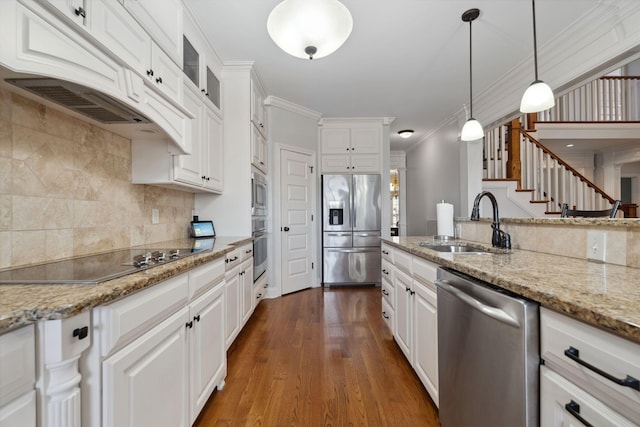 kitchen with stainless steel appliances, sink, white cabinets, and light stone counters