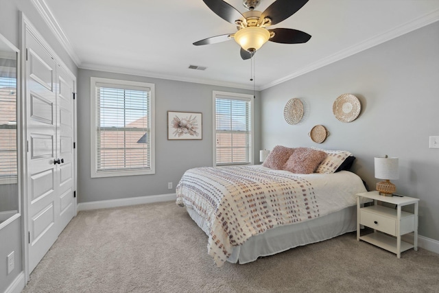 bedroom with crown molding, light carpet, and ceiling fan