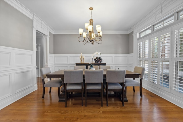 dining room featuring ornamental molding, dark hardwood / wood-style floors, and a notable chandelier