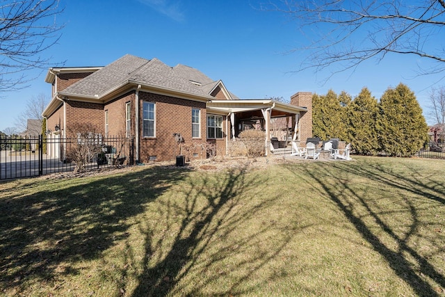 back of house featuring a yard and a patio area