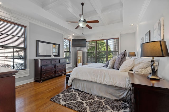 bedroom featuring ornamental molding, coffered ceiling, and light hardwood / wood-style floors