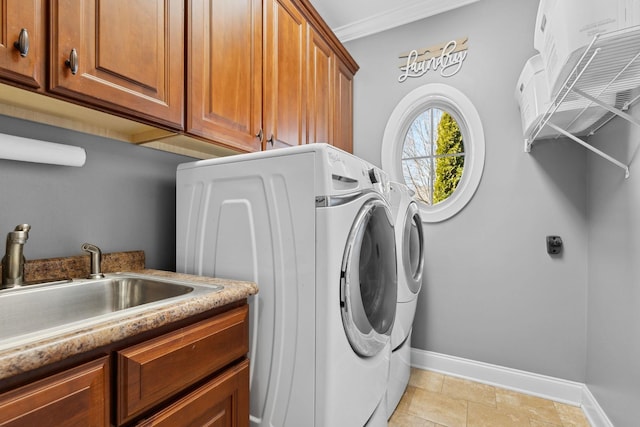 laundry area featuring crown molding, cabinets, sink, and washer and dryer