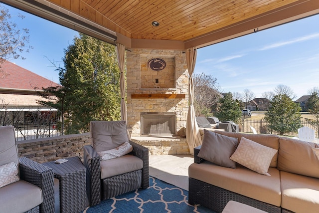 view of patio / terrace featuring an outdoor stone fireplace