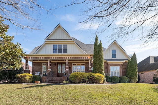 craftsman inspired home with a porch and a front lawn