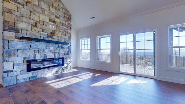 unfurnished living room featuring lofted ceiling, a stone fireplace, baseboards, ornamental molding, and dark wood-style floors