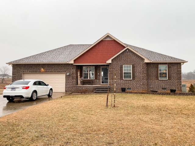 ranch-style house with a garage and a front yard