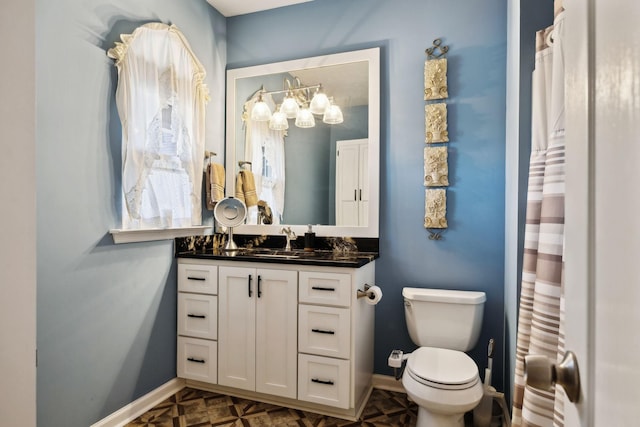 bathroom featuring parquet flooring, vanity, and toilet