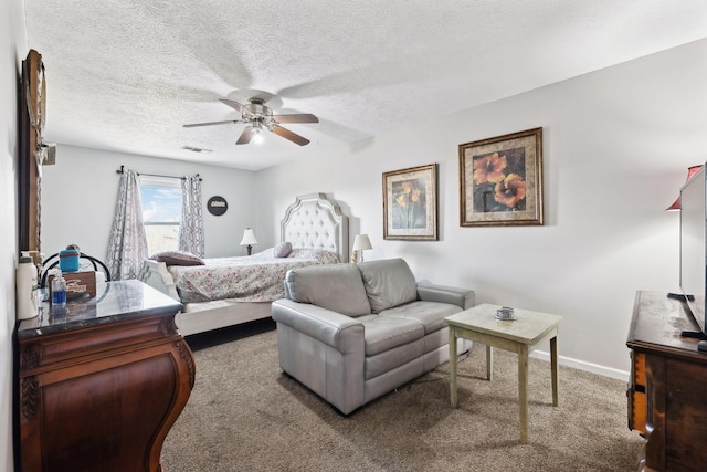 carpeted bedroom featuring a textured ceiling and ceiling fan