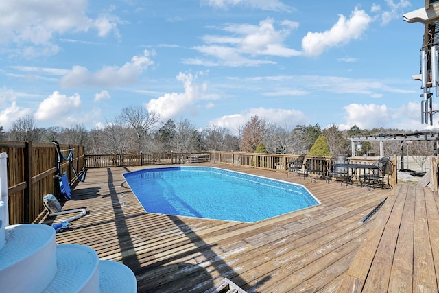 view of swimming pool featuring a wooden deck and a pergola