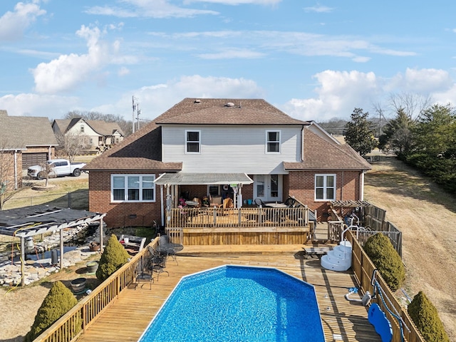 back of house with a pool side deck