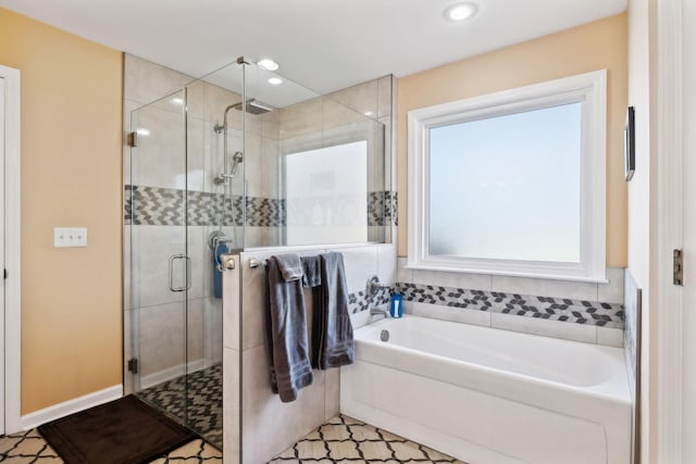 bathroom with shower with separate bathtub