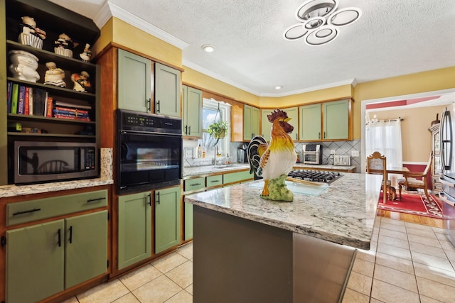 kitchen featuring light tile patterned floors, black oven, green cabinets, a center island, and light stone counters