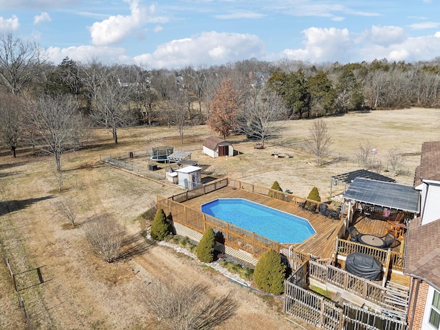 view of pool featuring a storage shed and a rural view