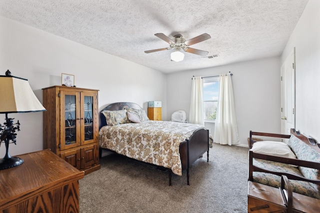 carpeted bedroom with a textured ceiling and ceiling fan