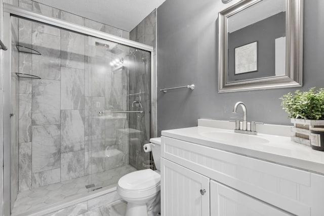 bathroom featuring vanity, toilet, and a shower with shower door