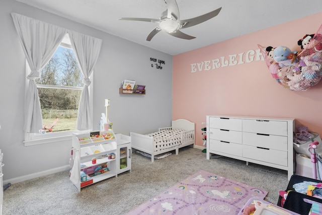 bedroom featuring multiple windows, light carpet, and ceiling fan