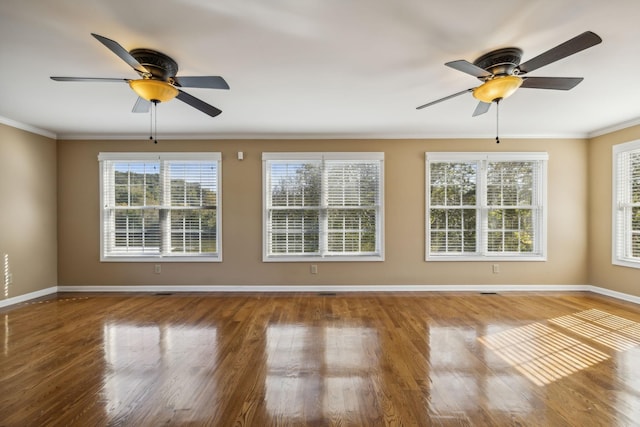 unfurnished room featuring crown molding, wood-type flooring, and ceiling fan