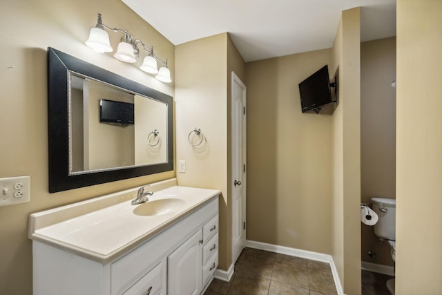 bathroom featuring tile patterned flooring, vanity, and toilet