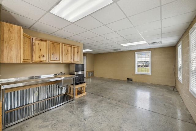 basement featuring a paneled ceiling