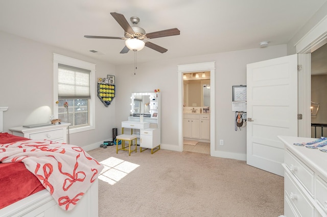 carpeted bedroom featuring ceiling fan, ensuite bath, and sink