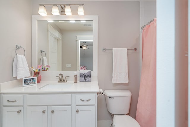 bathroom with vanity, toilet, and curtained shower