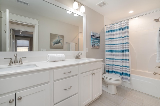 full bathroom with vanity, toilet, and shower / bath combo with shower curtain