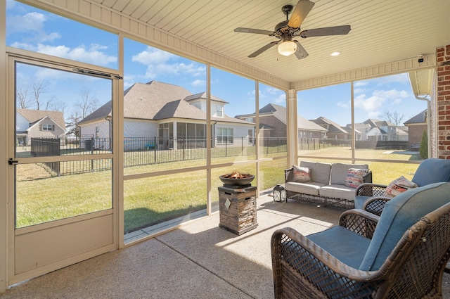 sunroom featuring wood ceiling and ceiling fan