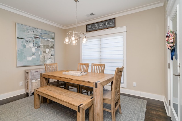 dining space with ornamental molding, dark hardwood / wood-style floors, and a notable chandelier