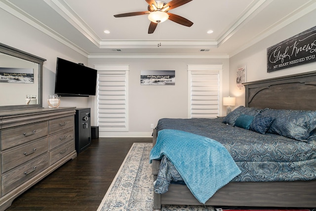 bedroom with ceiling fan, ornamental molding, dark hardwood / wood-style floors, and a raised ceiling