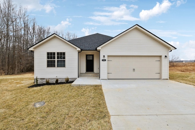 view of front of home featuring a garage and a front lawn