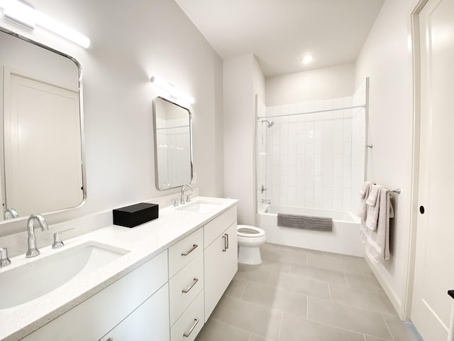 full bathroom with tile patterned flooring, vanity, tiled shower / bath combo, and toilet